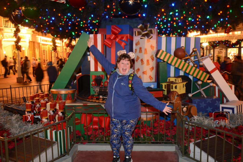PhotoPass picture in front of Magic Kingdom Christmas tree. 
